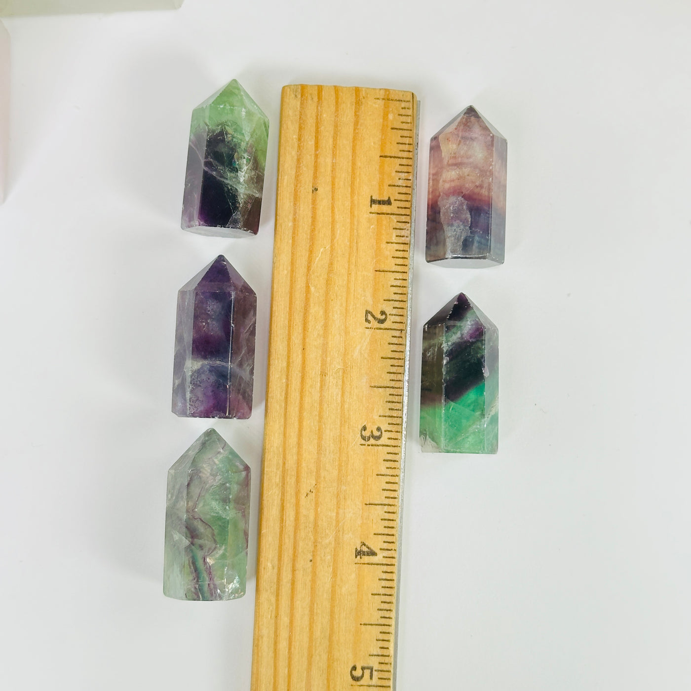 fluorite points next to a ruler for size reference