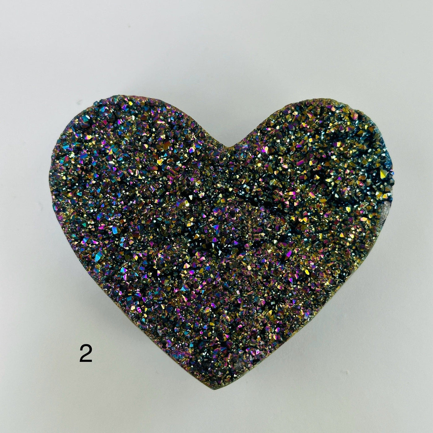 Rainbow titanium heart with decorations in the background