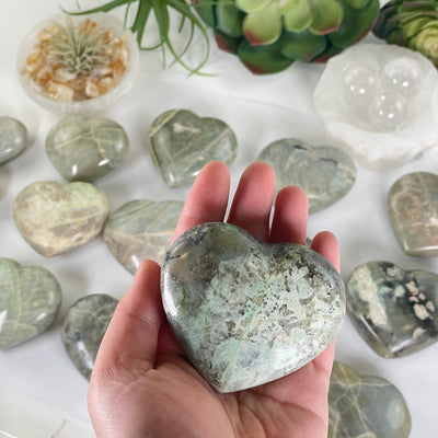 Garnierite Green Moonstone Crystal Heart - You Choose one in hand for size reference with other variants in the background
