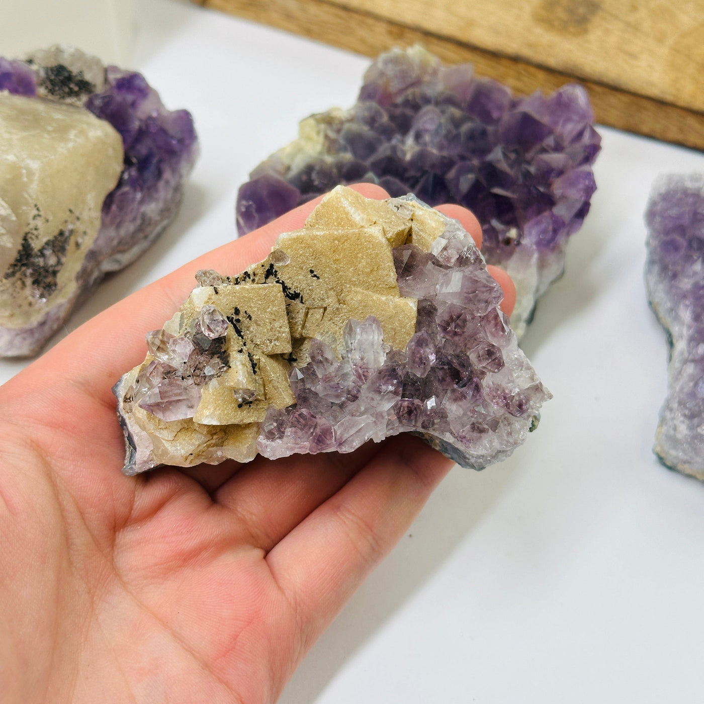 amethyst cluster with decorations in the background