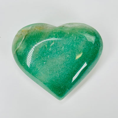 aventurine heart with decorations in  the background