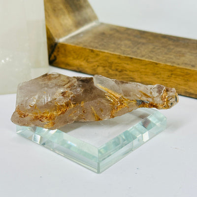 rutilated quartz with decorations in the background