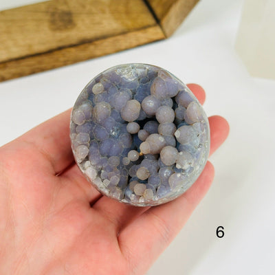 Grape agate cluster with decorations in the background