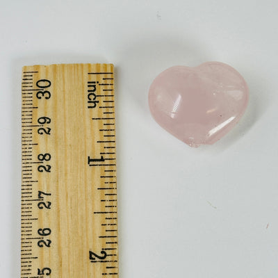 rose quartz hear next to a ruler for size reference