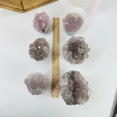 amethyst crystal flowers next to a ruler for size reference