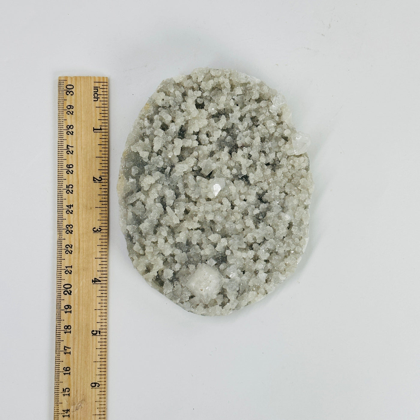 zeolite with apophyllite next to a ruler for size reference