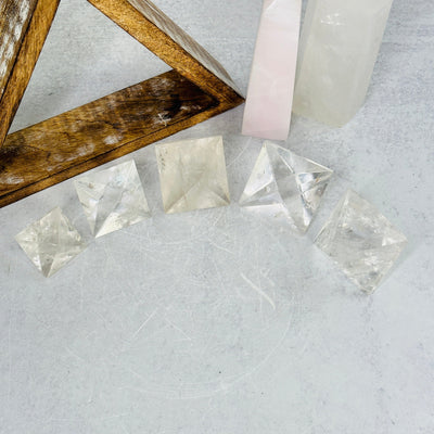 crystal quartz geometric shapes with decorations in the background