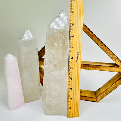 crystal quartz point next to a ruler for size reference