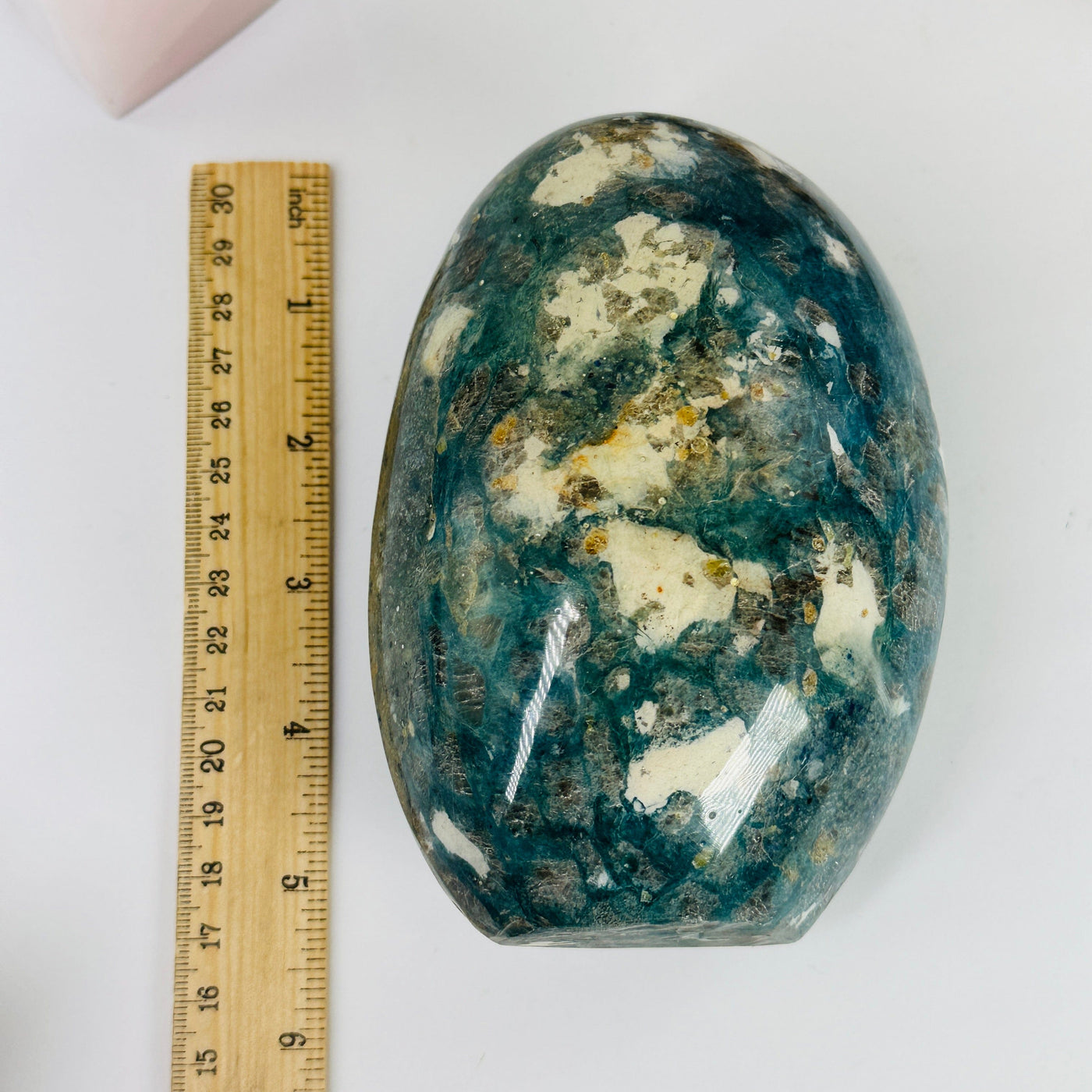 dumortierite cut base next to a ruler for size reference