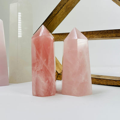 rose quartz point with decorations in the background