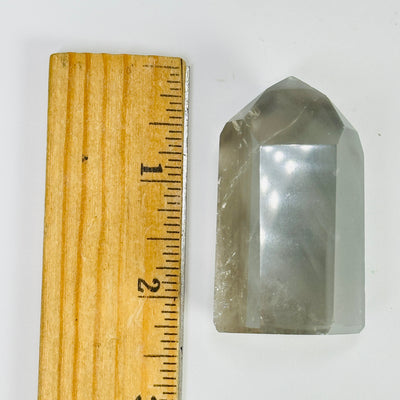 tourmaline point next to a ruler for size reference