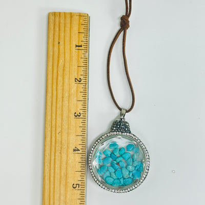 howlite ornament next to a ruler for size reference