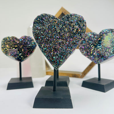 titanium coated heart on stand with decorations in the background