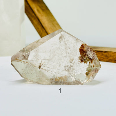 rutile quartz with decorations in the background