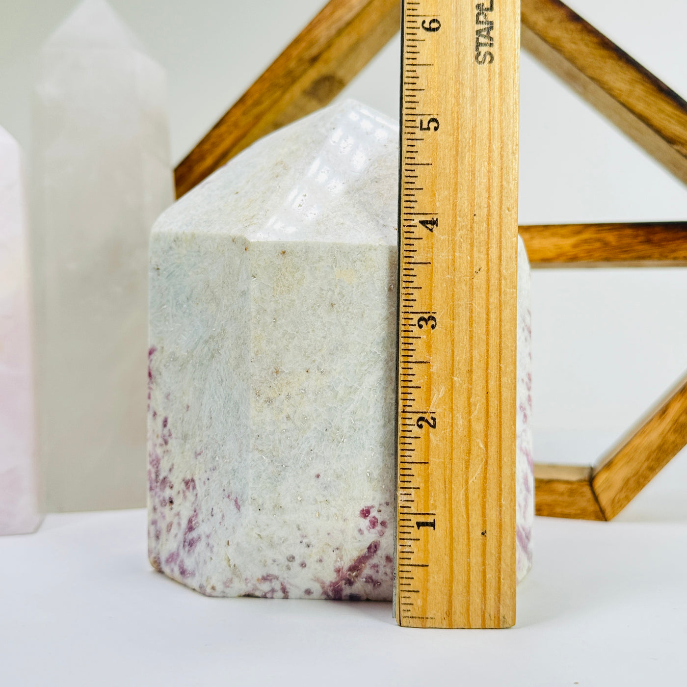 tourmaline point next to a ruler for size reference