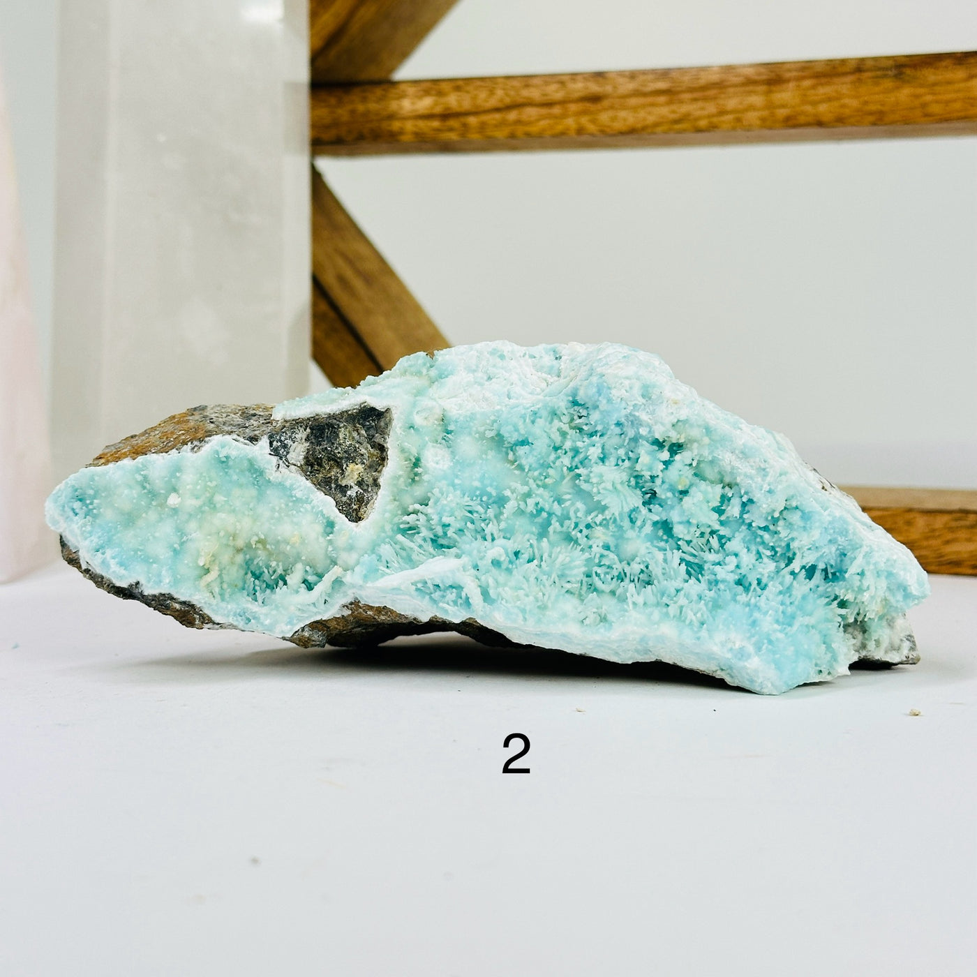 blue aragonite with decorations in the background