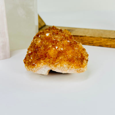 citrine cluster with decorations in the background