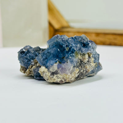 blue fluorite with decorations in the background