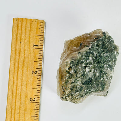 tourmaline next to a ruler for size reference