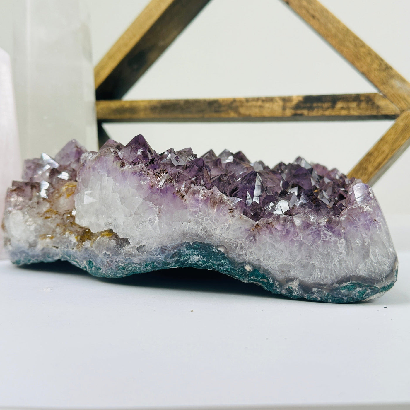 amethyst cluster with decorations in the background