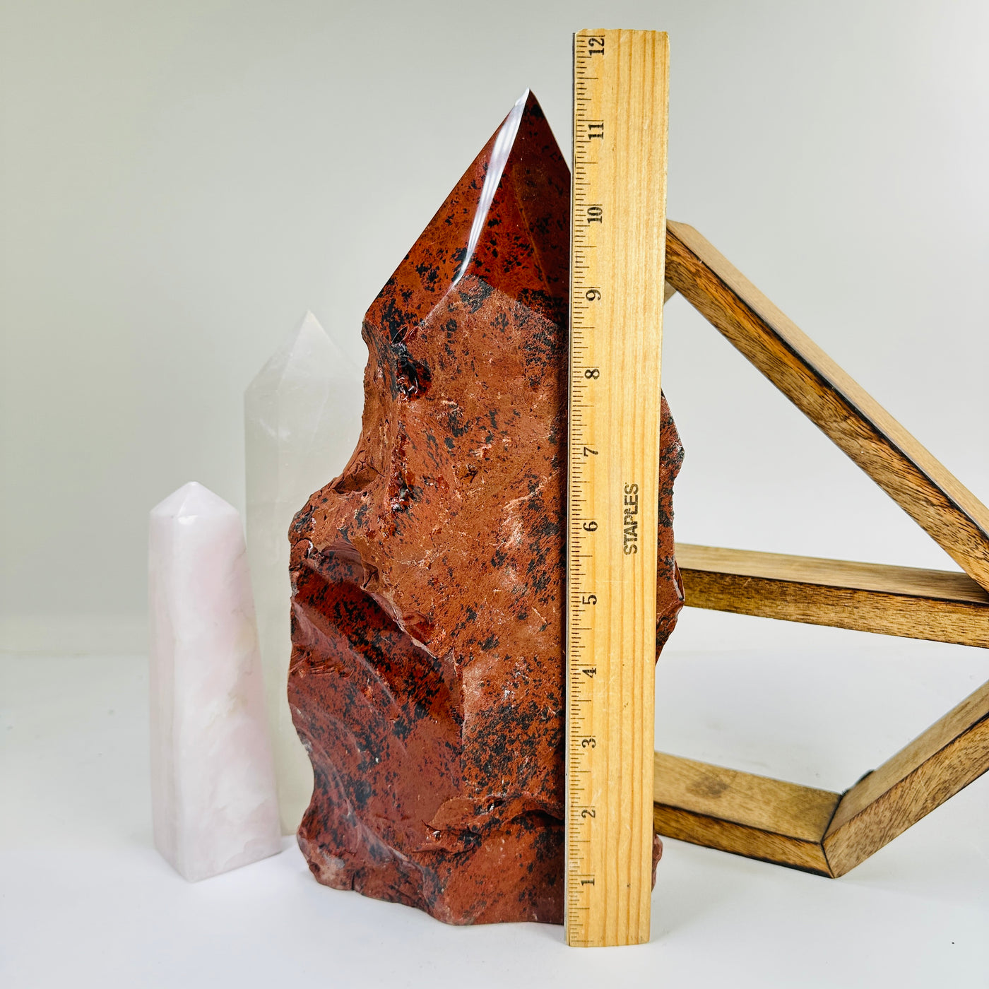 mahogany obsidian point next to a ruler for size reference