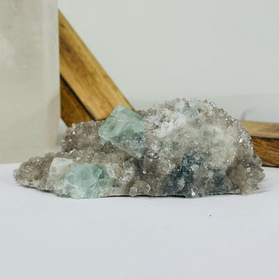 Blue fluorite crystal with decorations in the background