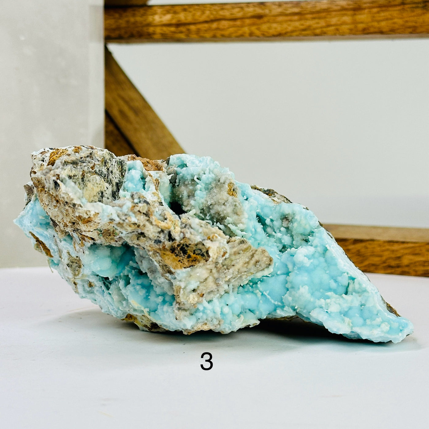 blue aragonite with decorations in the background