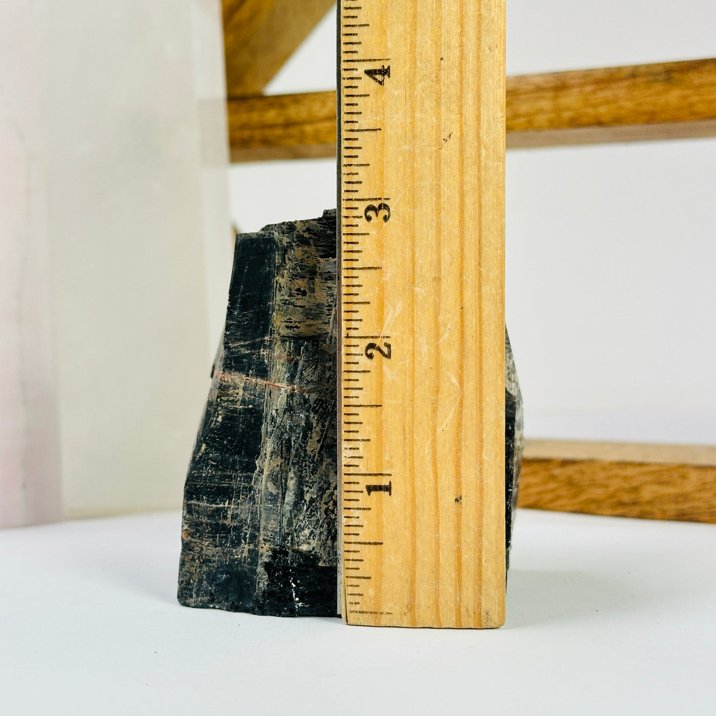 tourmaline point next to a ruler for size reference