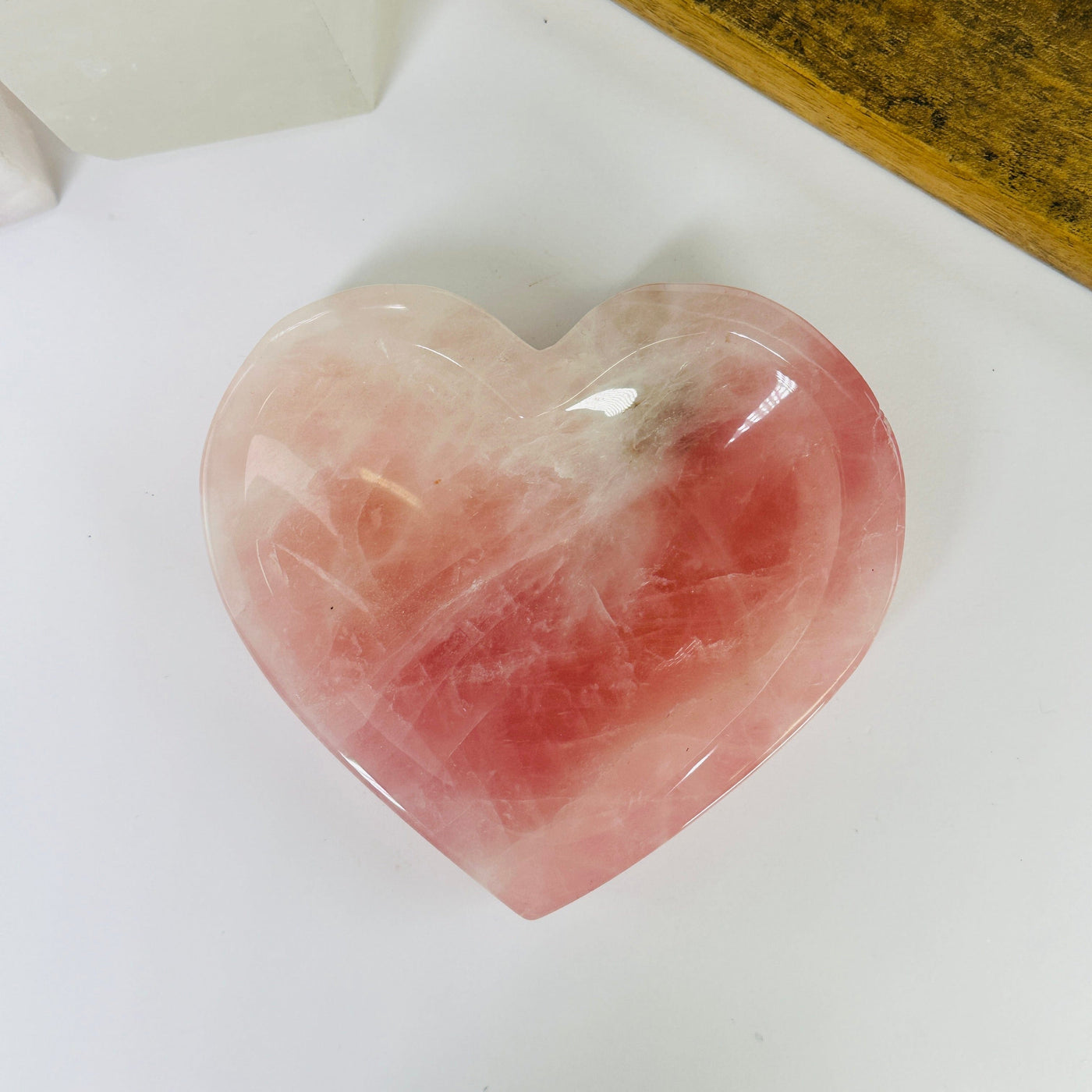 rose quartz heart bowl with decorations in the background
