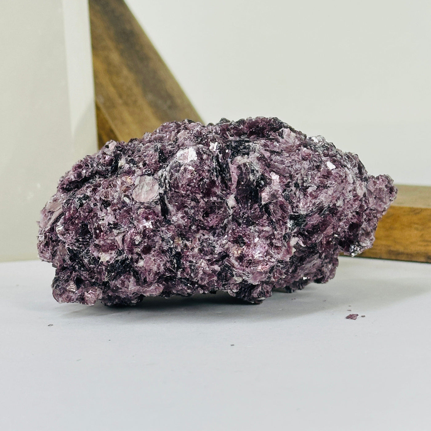 lepidolite cluster with decorations in the background