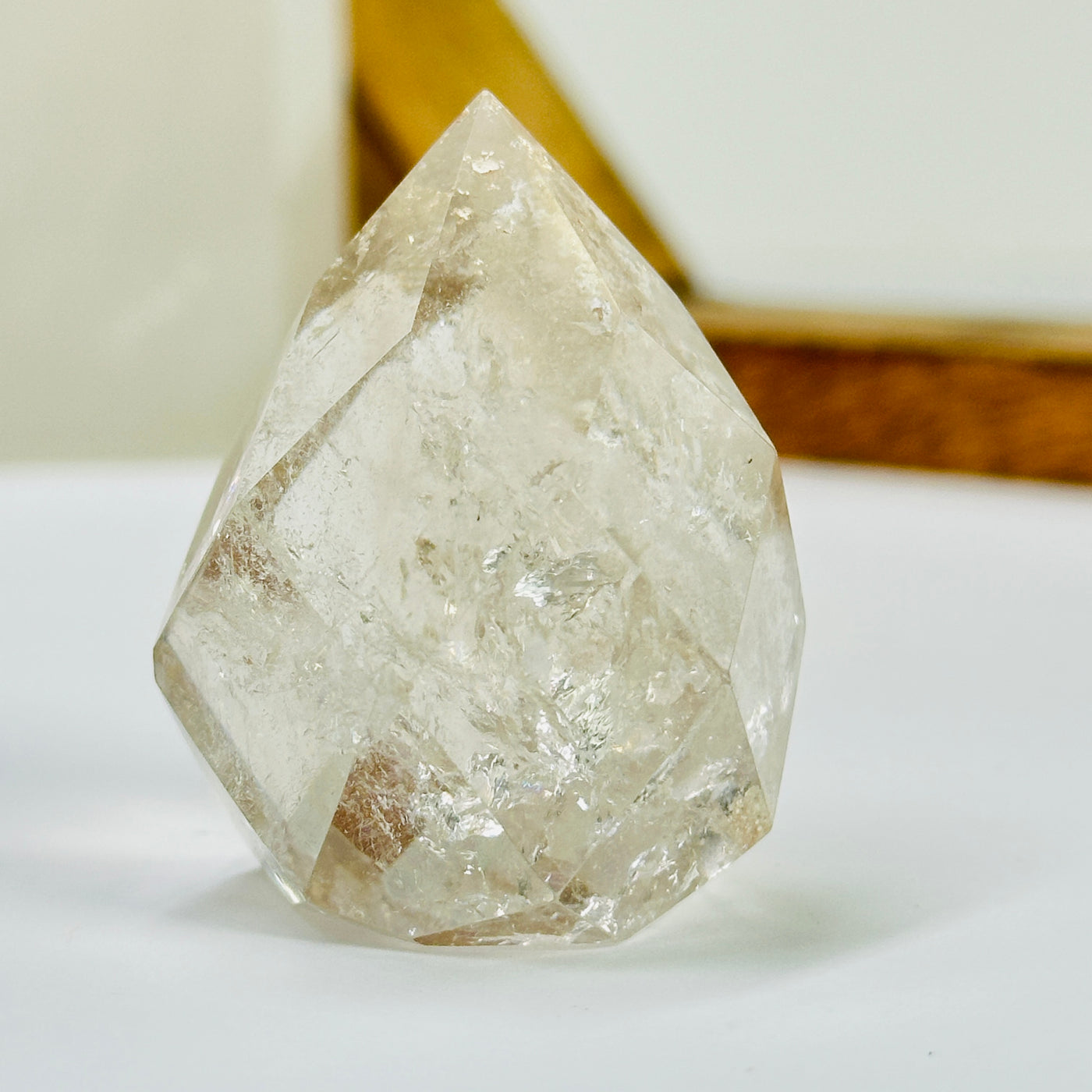 crystal quartz point with decorations in the background