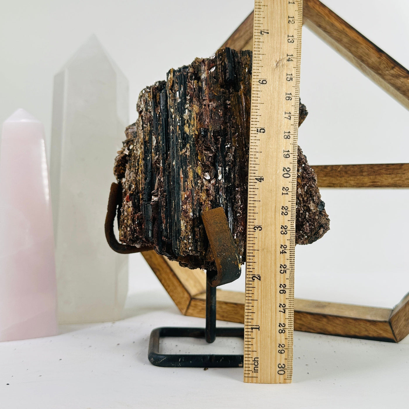 Tourmaline with mica on Metal stand next to a ruler for size reference