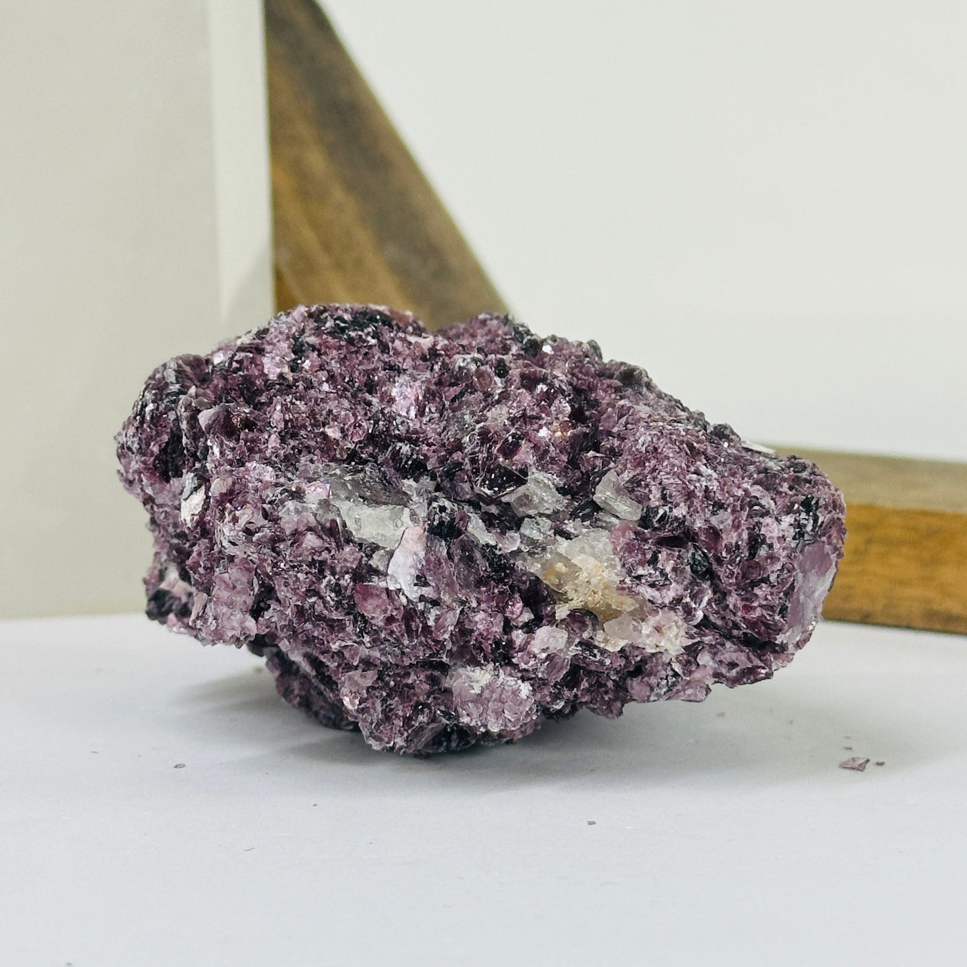 lepidolite cluster with decorations in the background