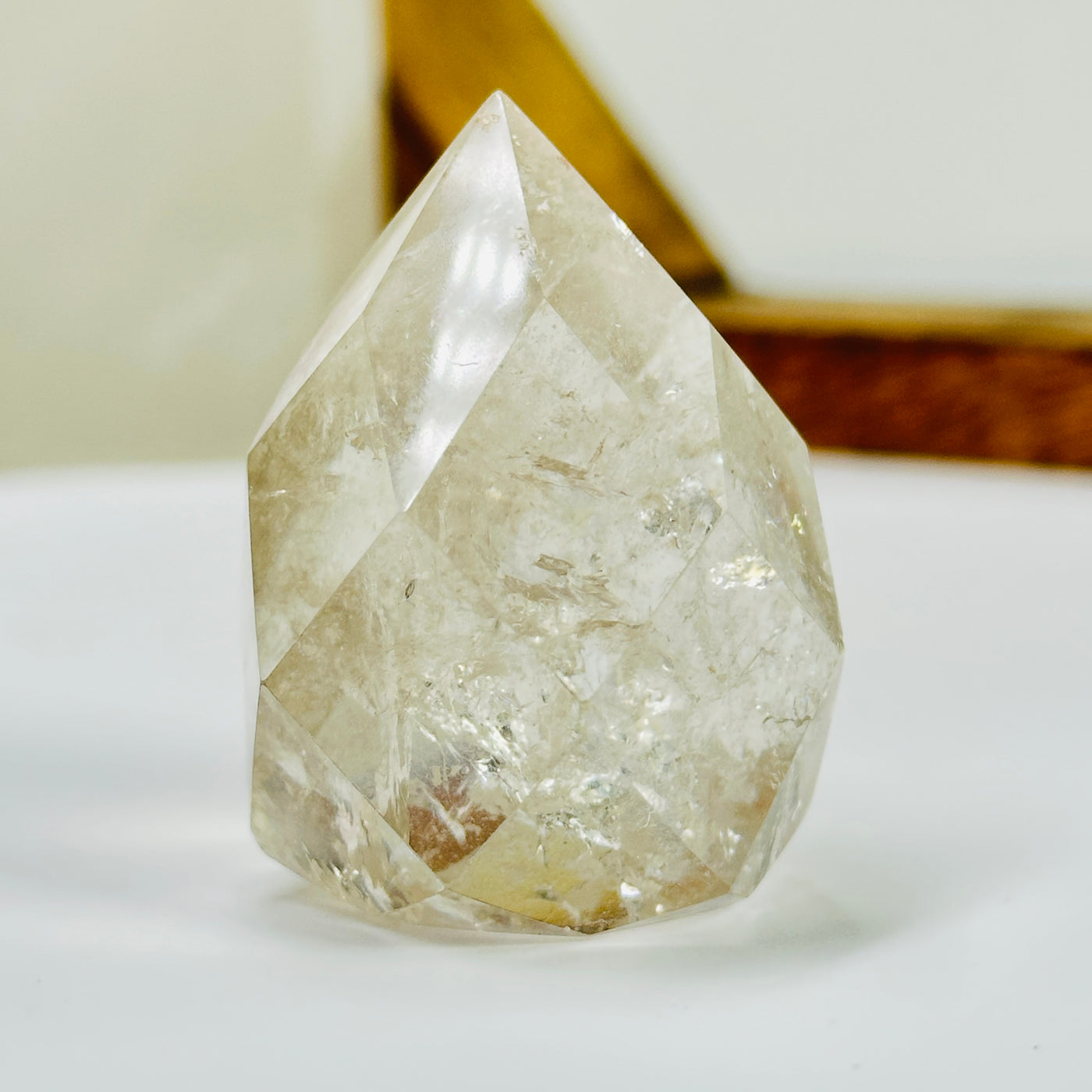 crystal quartz point with decorations in the background