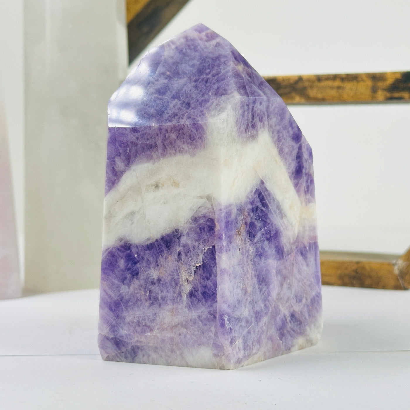 chevron amethyst polished point with decorations in the background