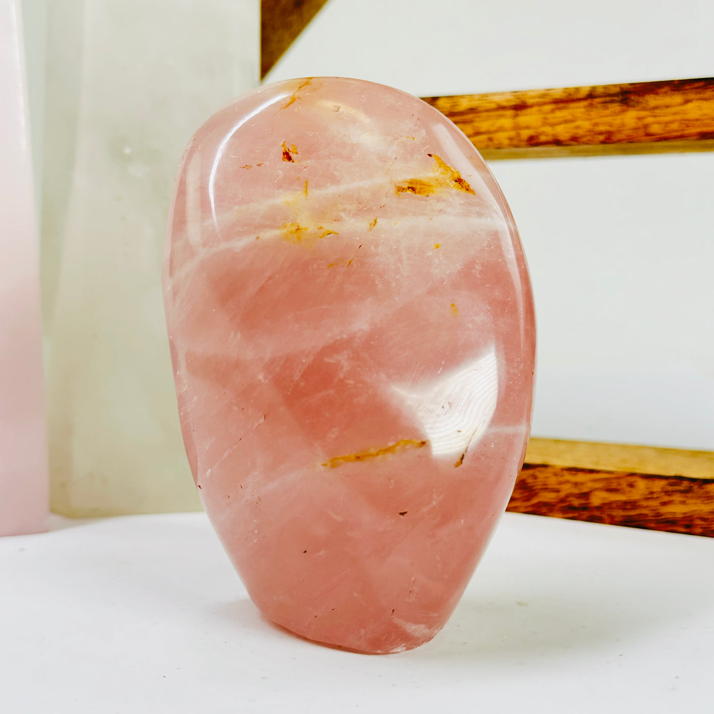 rose quartz cut base with decorations in the background