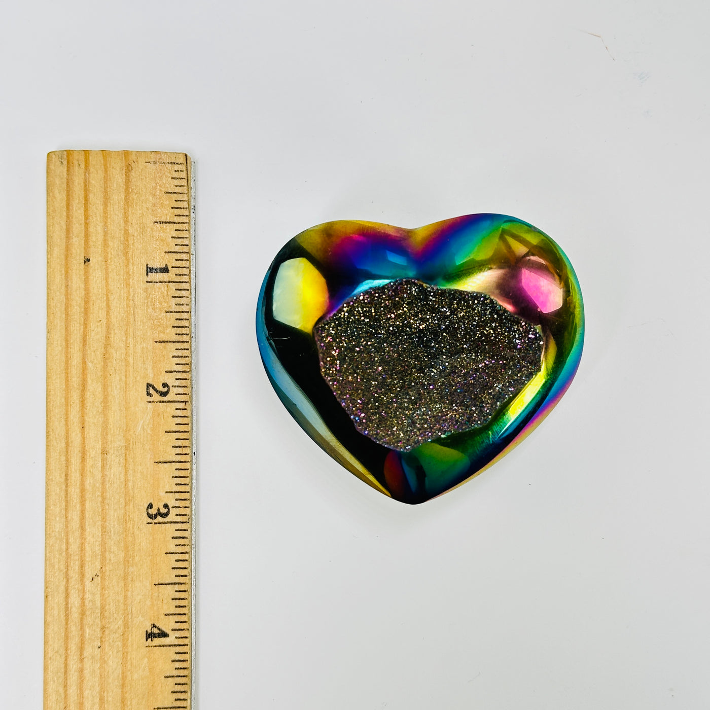 titanium coated heart next to a ruler for size reference