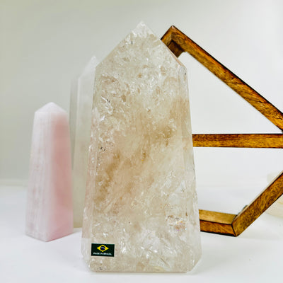 crystal quartz point with decorations in the background