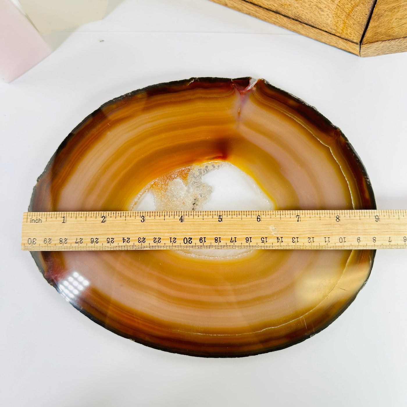 agate slice next to a ruler for size reference