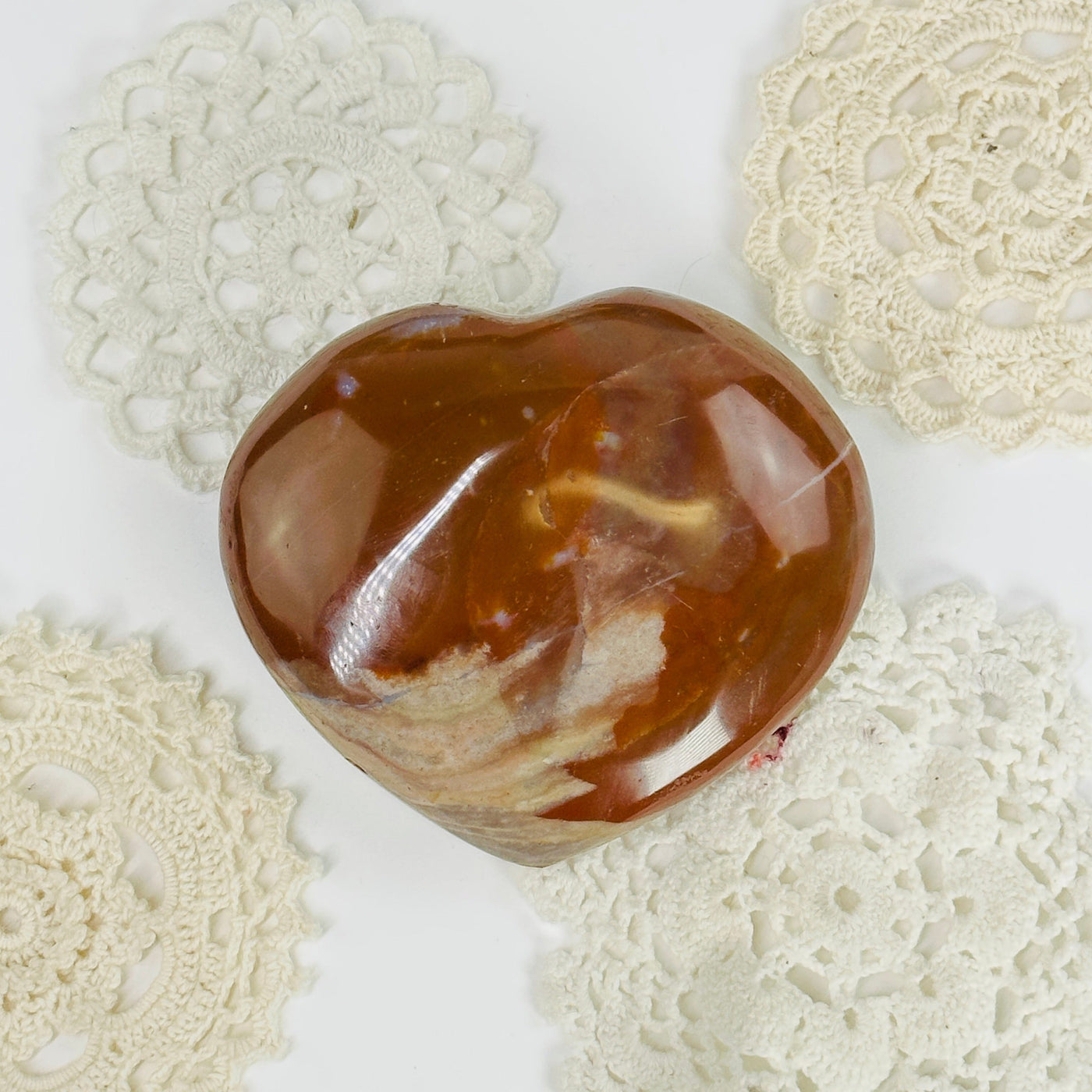 carnelian heart with decorations in the background