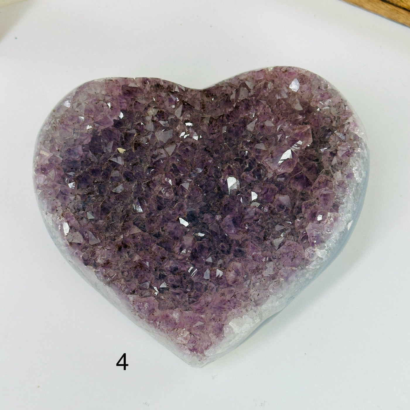 amethyst heart with decorations in the background