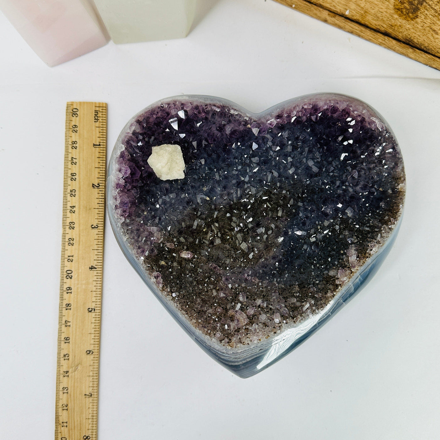 amethyst heart next to a ruler for size reference