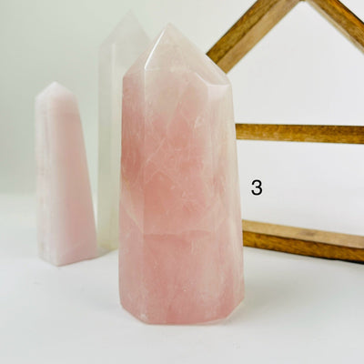 rose quartz points with decorations in the background