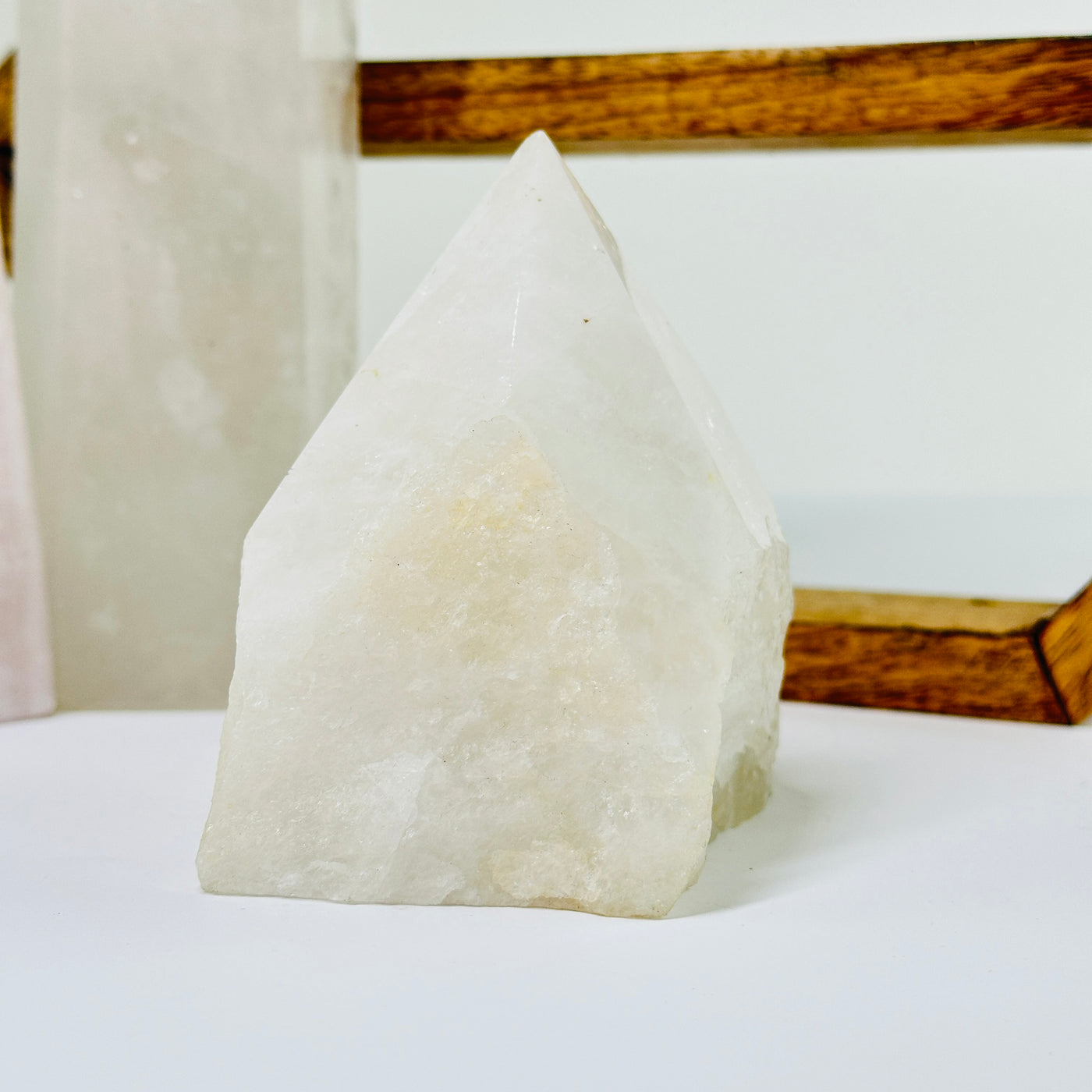 crystal quartz point with decorations in the background