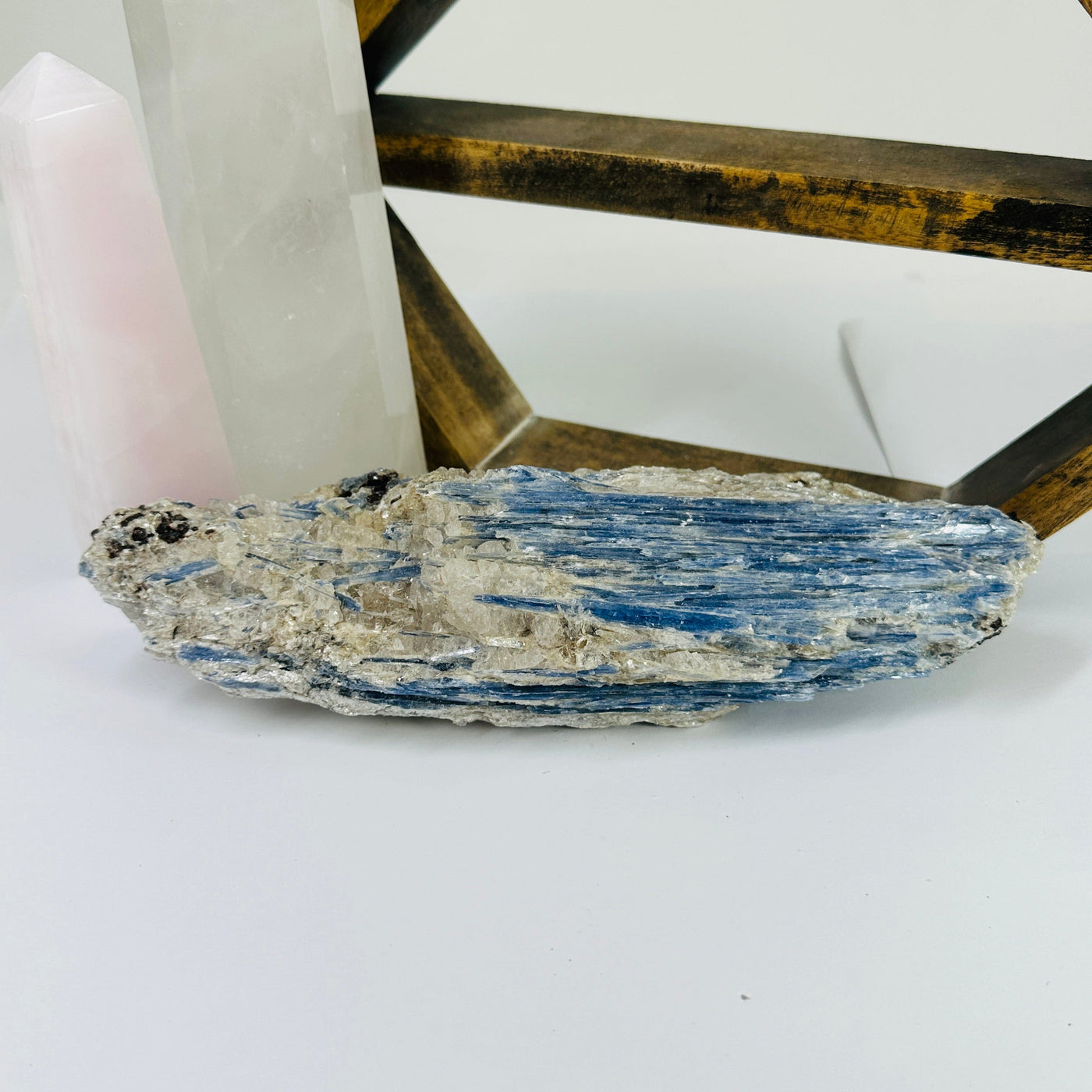 Kyanite with decorations in the background