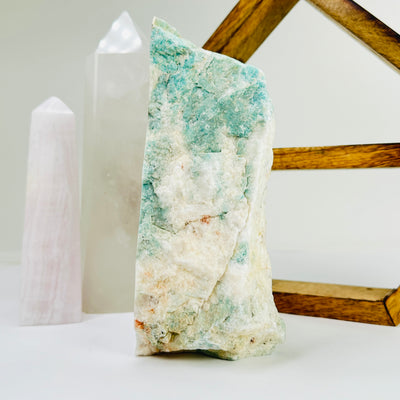 amazonite cut base with decorations in the background