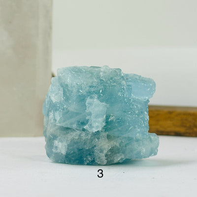 aquamarine stone with decorations in the background