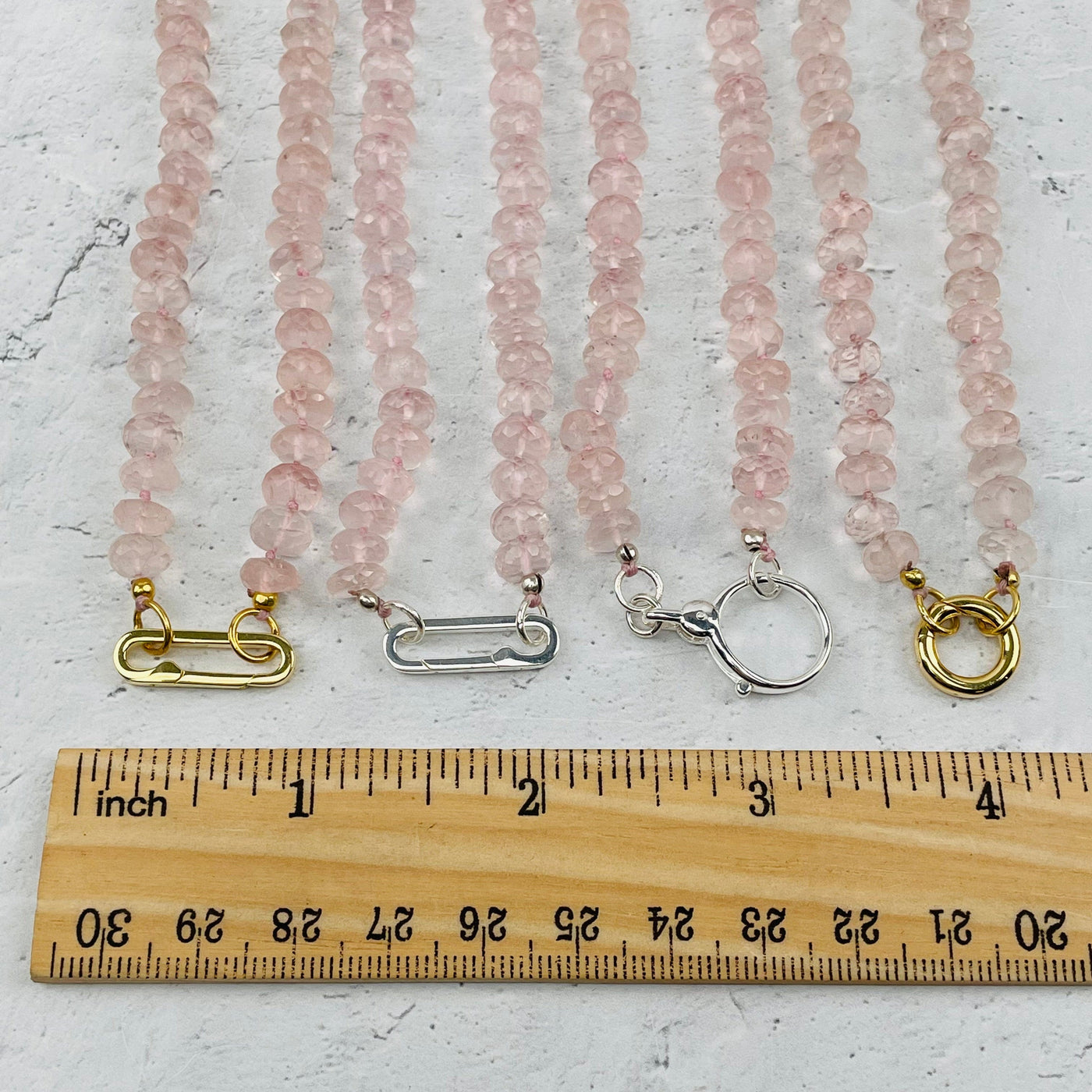 clasps next to a ruler for size reference 