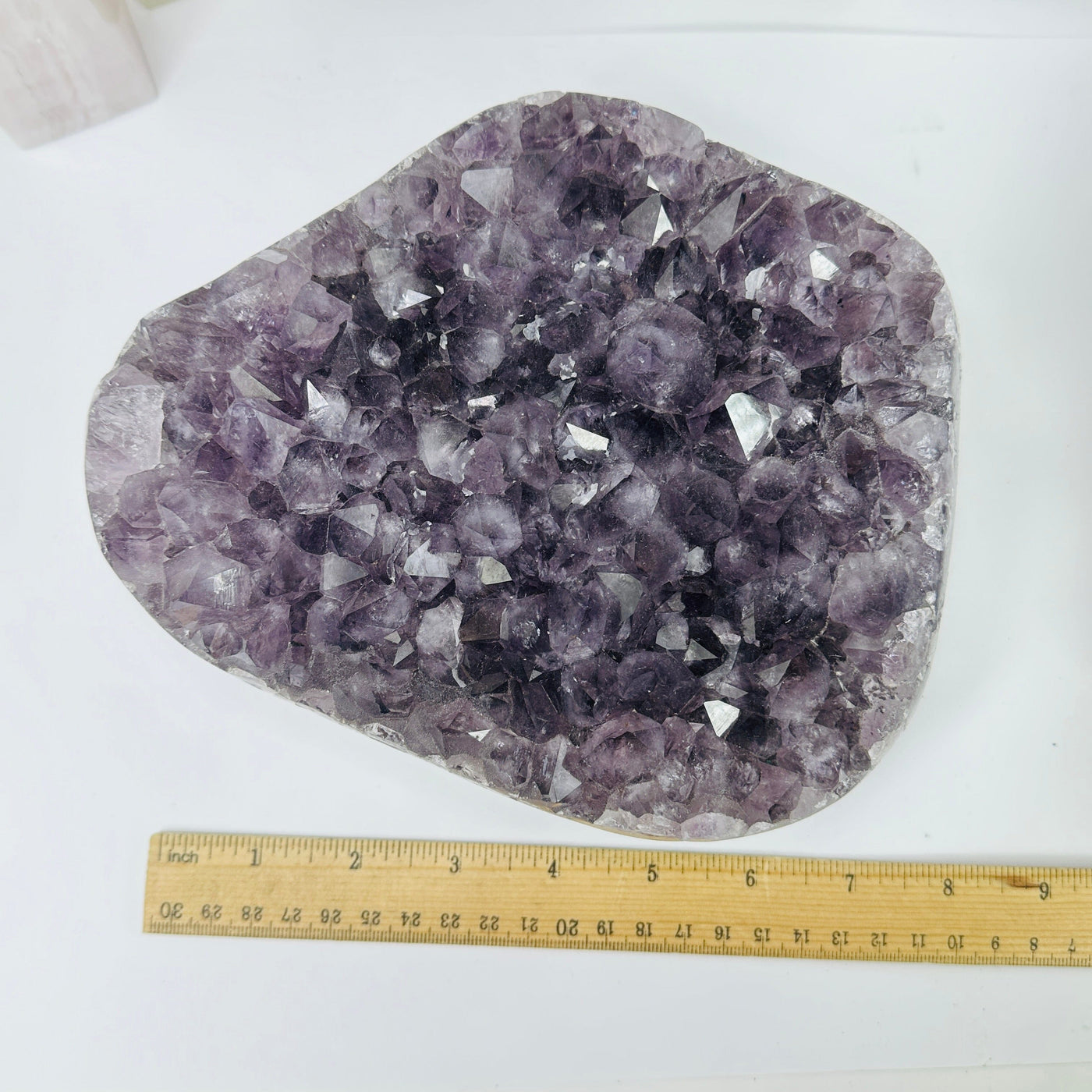 amethyst cluster with decorations in the background