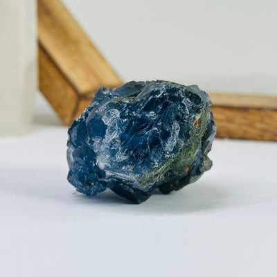 Blue fluorite crystal with decorations in the background